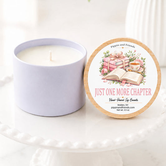 A soy candle in a white ceramic vessel with a natural wood lid featuring a watercolor book themed, hand-poured by Pippin and Friends