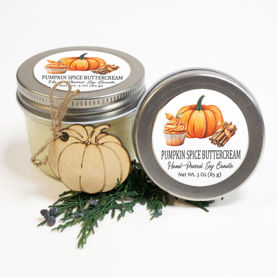 two jars of pumpkin spice buttercream, one with a lid and the other with a lid and a wooden decoration.