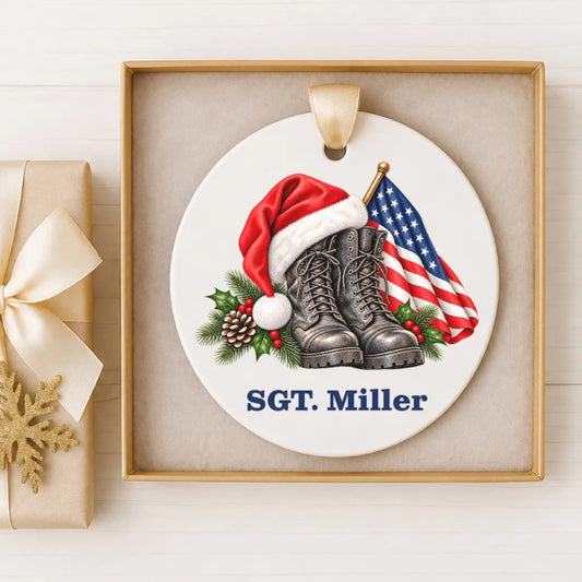 A ceramic ornament with a Santa hat, boots, and an American flag, along with the name 'SGT. Miller' written on it.