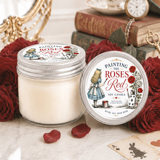 Alice in Wonderland inspired floral soy candle with red roses and vintage tea party aesthetic on elegant vanity table.