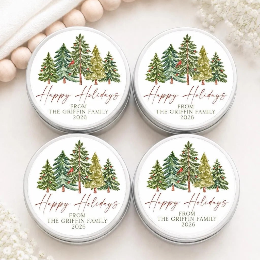four circular labels with a Christmas tree design, placed on a white surface.