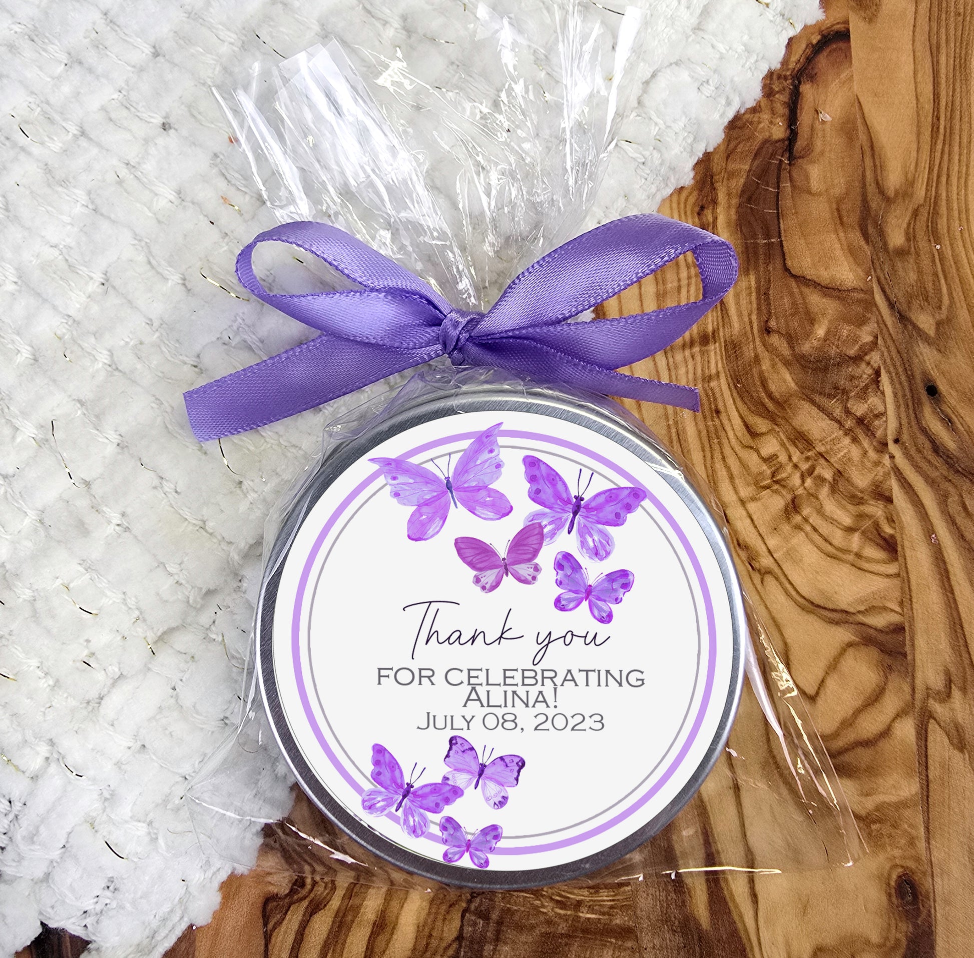 a jar of personalized candles with a purple ribbon