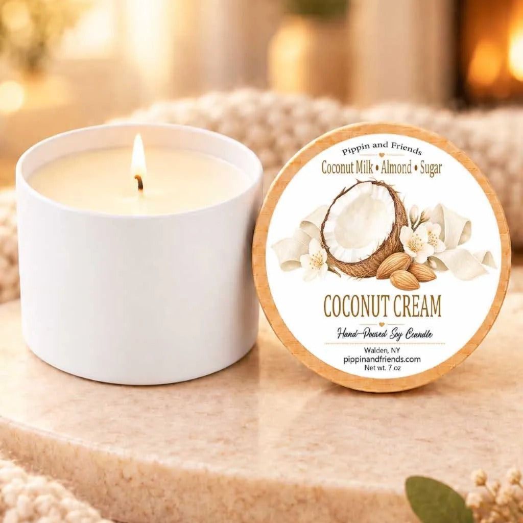 a white candle with a label next to it, both placed on a beige surface.