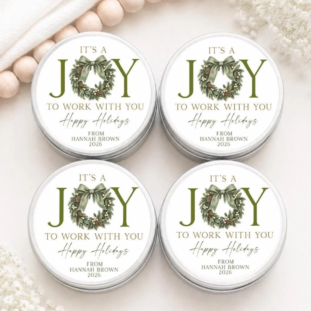 four round tin cans with holiday-themed labels, each featuring a wreath design and the text "It's a JOY to WORK WITH YOU Happy Holidays FROM HANNAH BROWN 2020".