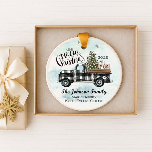A Christmas ornament featuring a black and white checkered truck with a Christmas tree and presents in the back.