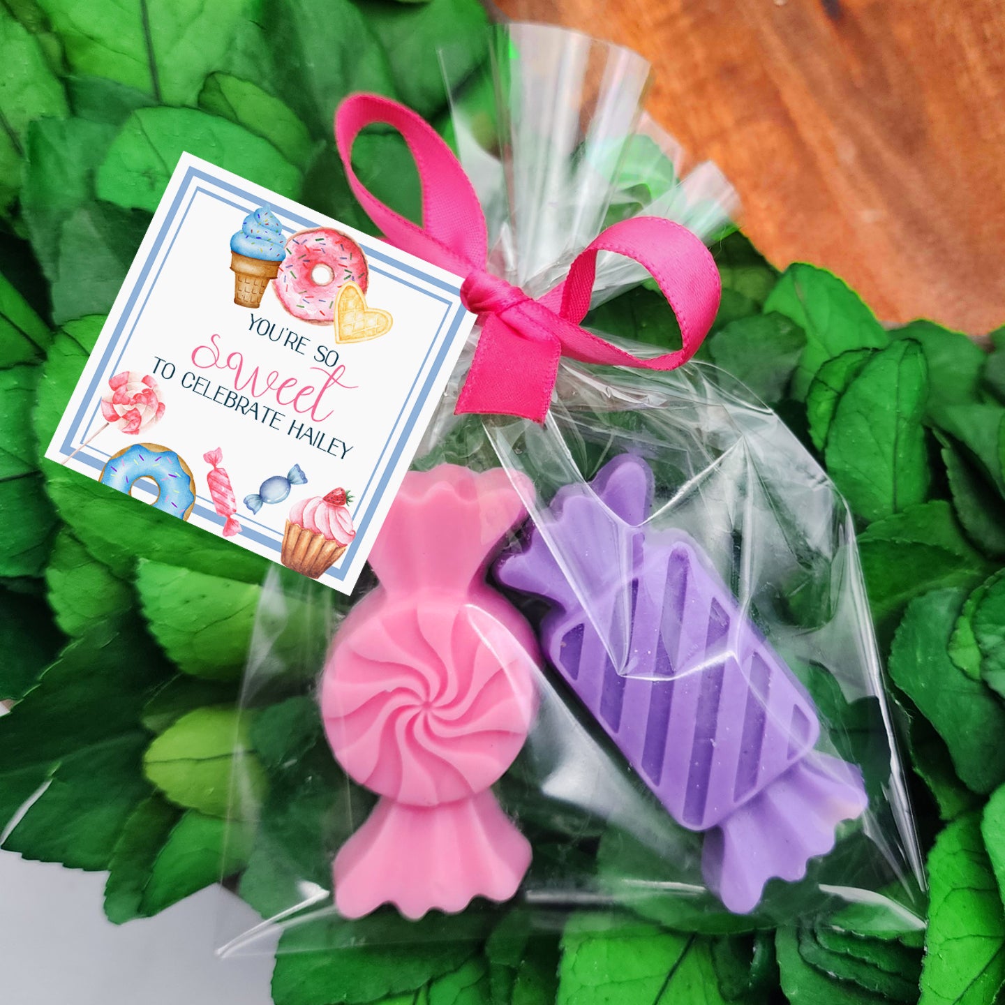 a bouquet of green leaves with a pink ribbon