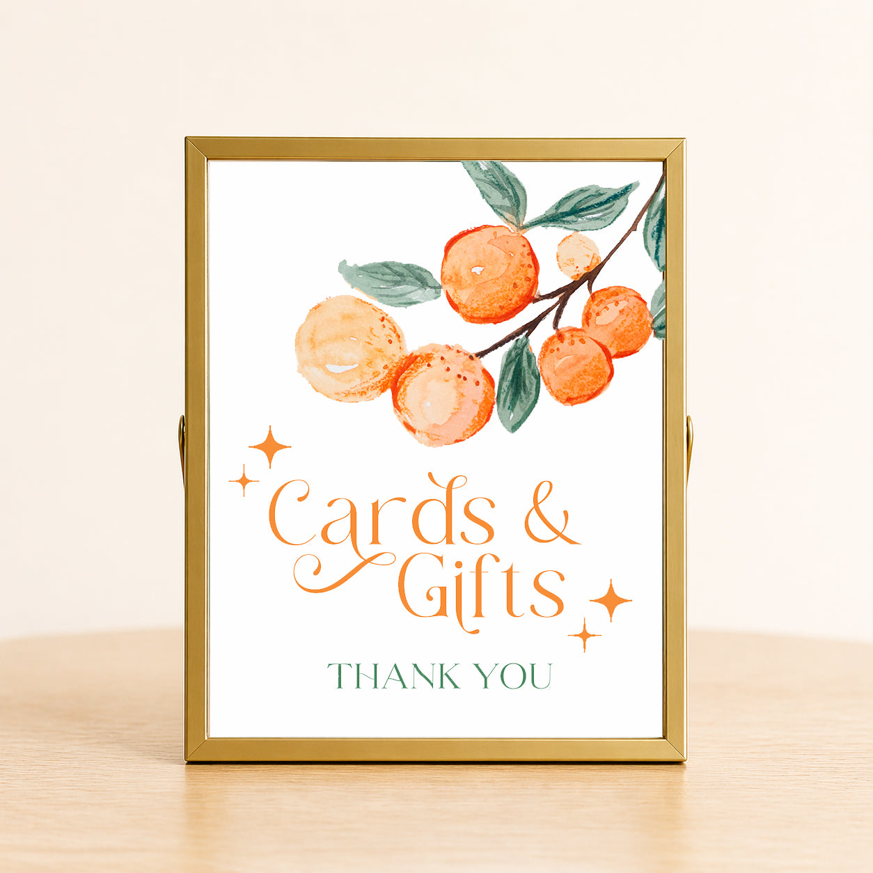 A Little Cutie baby shower cards and gifts sign with citrus design displayed on table for gift station decor.