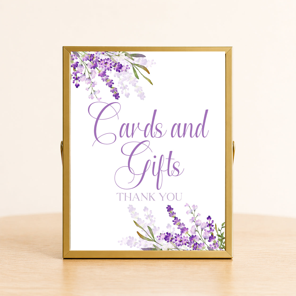 Lavender cards and gifts sign with purple floral design displayed on table for bridal shower or wedding gift table decor.