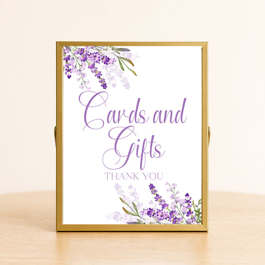 Lavender cards and gifts sign with purple floral design displayed on table for bridal shower or wedding gift table decor.