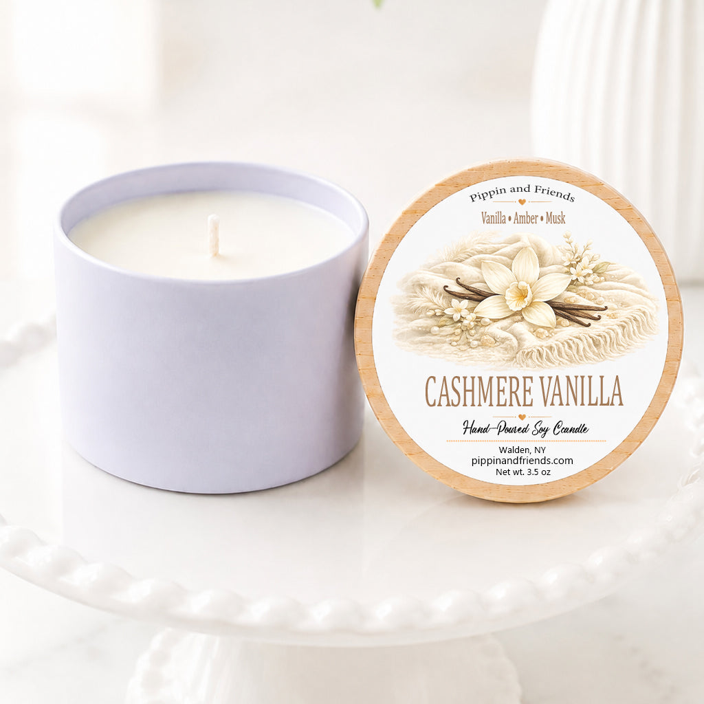 Vanilla scented soy candle in a white ceramic vessel with a natural wood lid featuring a watercolor vanilla label, hand-poured by Pippin and Friends