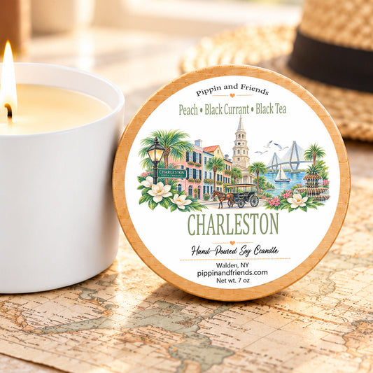 Charleston destination soy candle with peach, black currant and black tea fragrance in 7 oz white tin with wood-look lid.