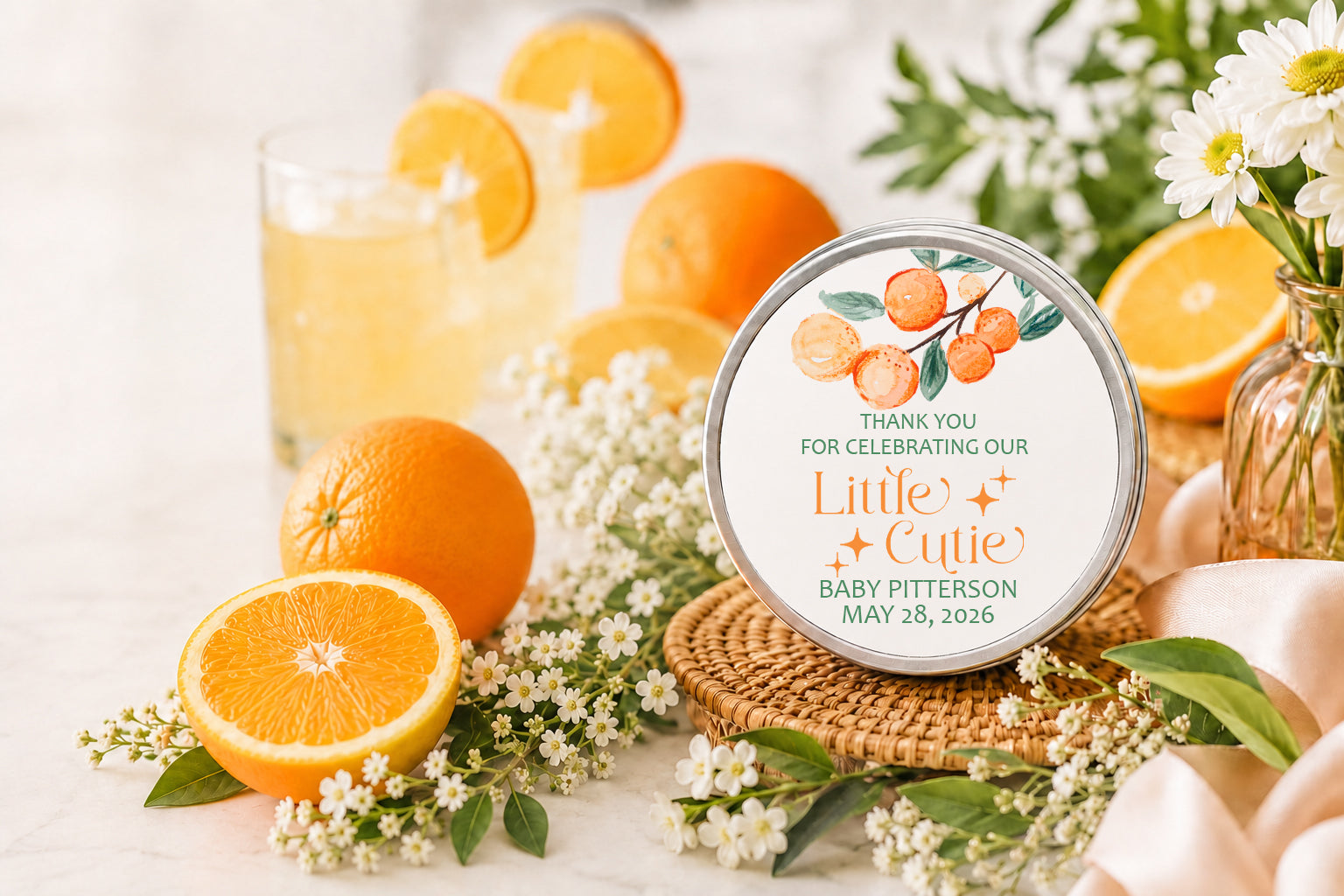 “Personalized citrus baby shower candle favor featuring fresh oranges, white florals, and a custom ‘Little Cutie’ label displayed on a woven tray with citrus drinks and elegant spring decor.”
