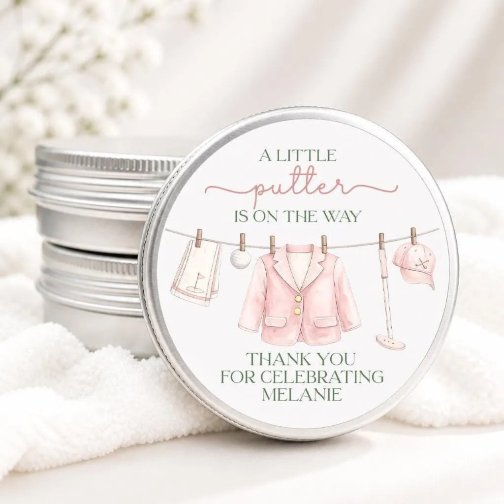 A round tin with a label that says "A little putter is on the way" and "Thank you for celebrating Melanie"
