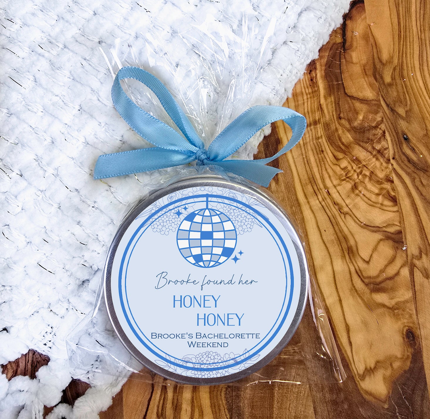 a jar of honey sits on a white rug
