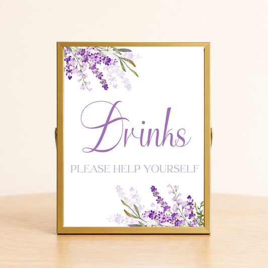 Lavender drinks sign with purple floral design displayed on table for bridal shower or wedding drink station decor.