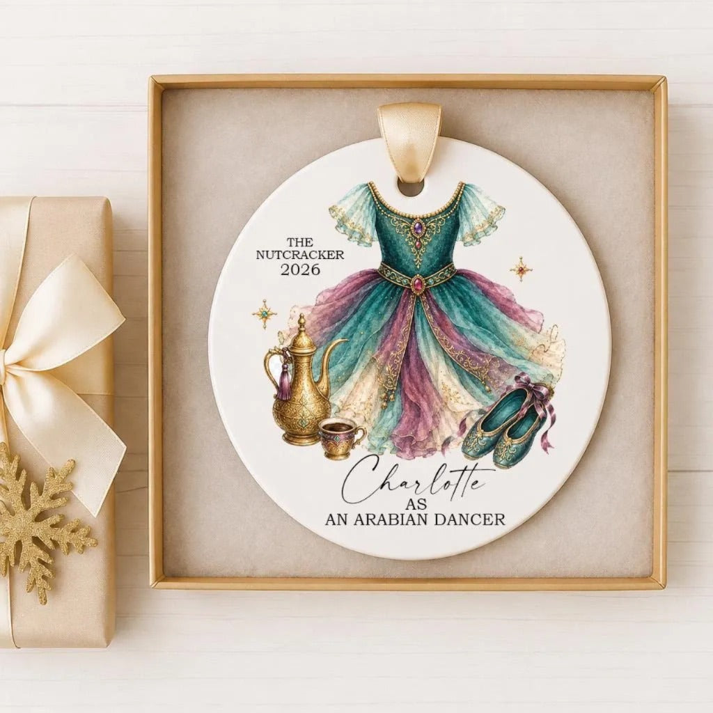 A decorative ornament featuring a colorful ballerina dress, a teapot, and a pair of ballet slippers, with the text "The Nutcracker 2020 Charlotte as an Arabian dancer" on it.