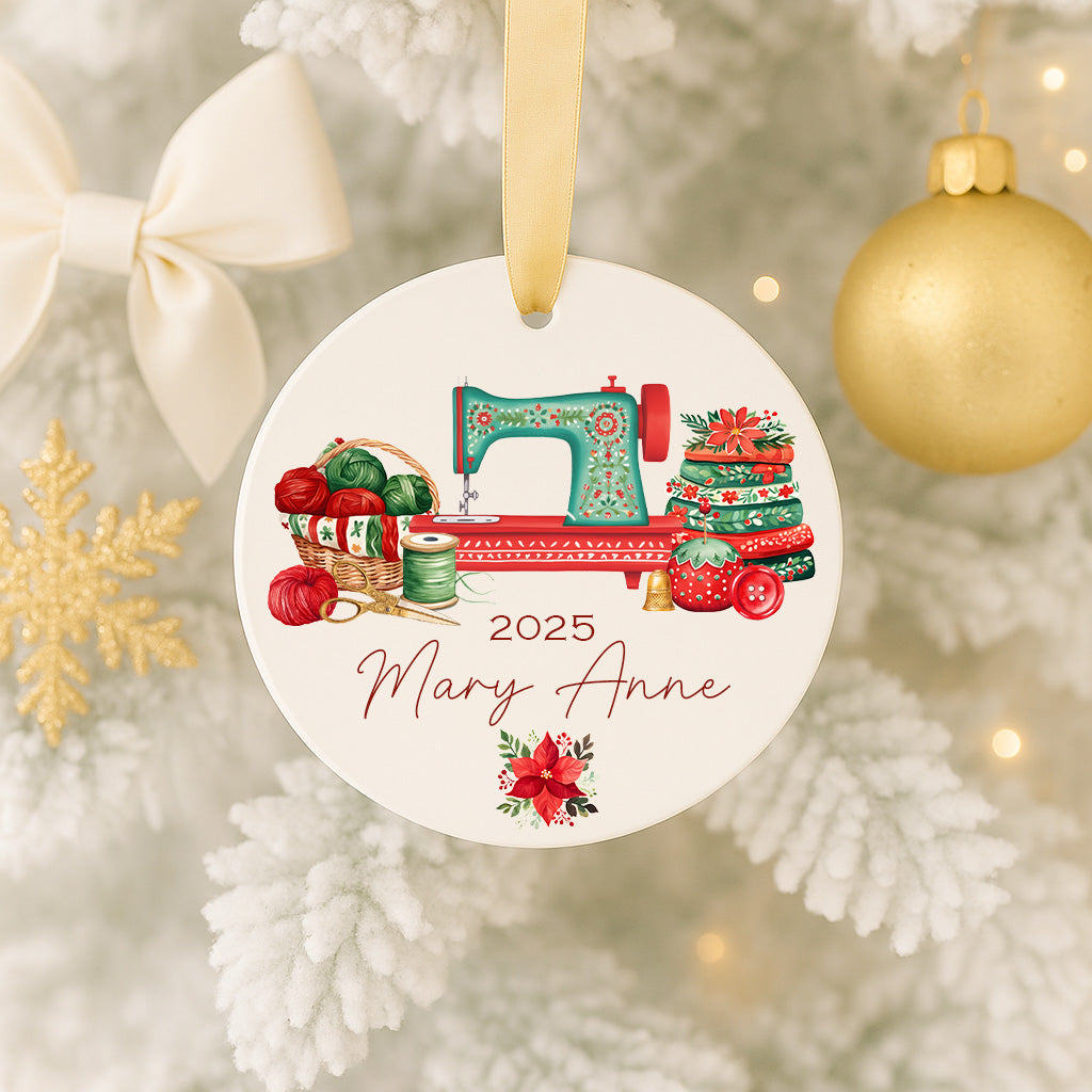 A Christmas ornament featuring a sewing machine surrounded by various sewing-related items, such as a basket of yarn and a stack of fabric, with the name "Mary Anne" written on it.