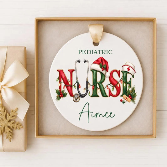 A decorative ornament with the word "NURSE" written on it, featuring a stethoscope and Christmas-themed elements. The ornament is displayed in a frame, and there is a gift box next to it.