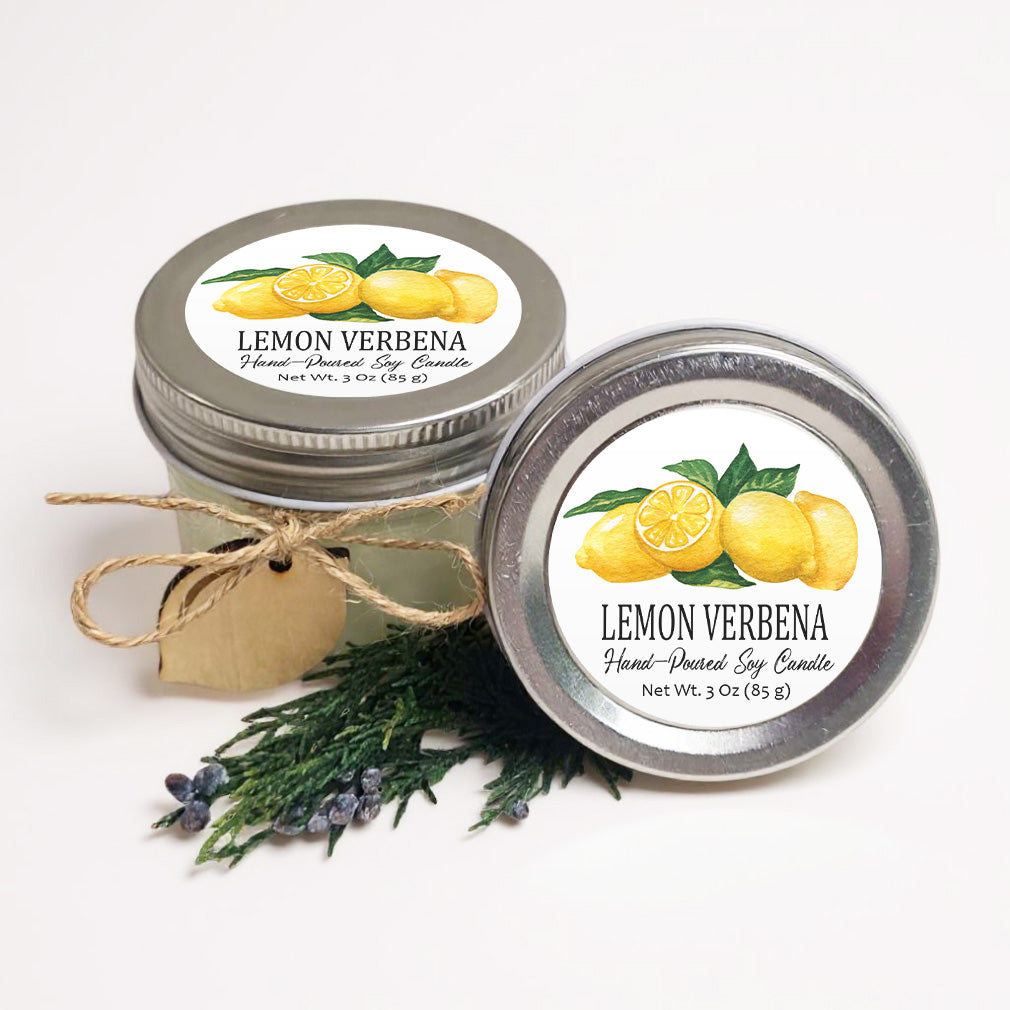 two jars of lemon verbena hand-poured soy candle, with a label that reads "LEMON VERBENA Hand-Poured Soy Candle Net WT. 3 OZ (85 g)" and a small wooden tag.