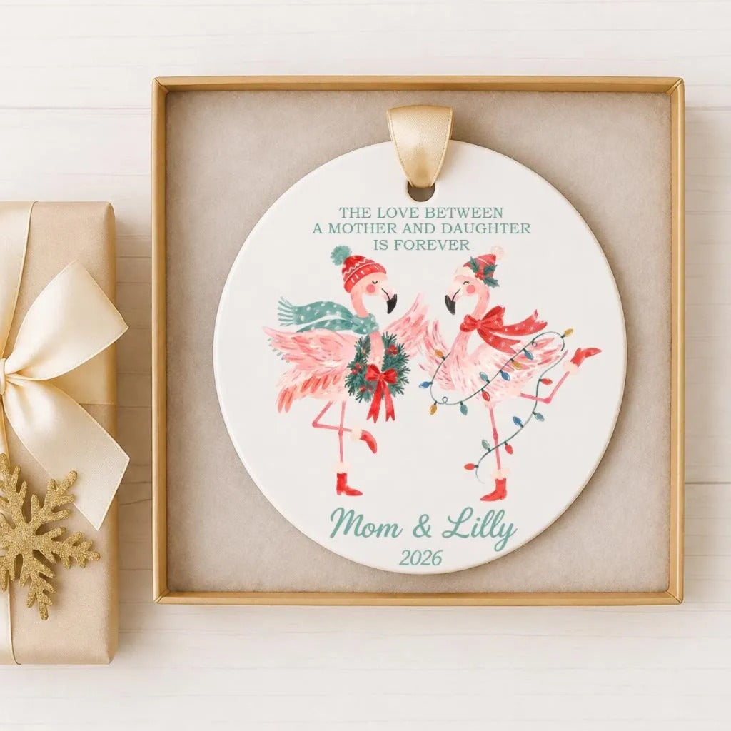 A ceramic ornament with a mother and daughter depicted, along with the text "The love between a mother and daughter is forever" and "Mom & Lilly 2026".