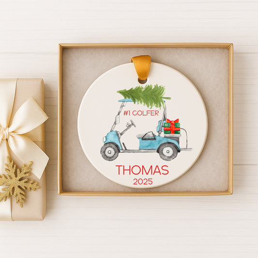 A ceramic ornament featuring a golf cart with a Christmas tree on top, placed in a box.