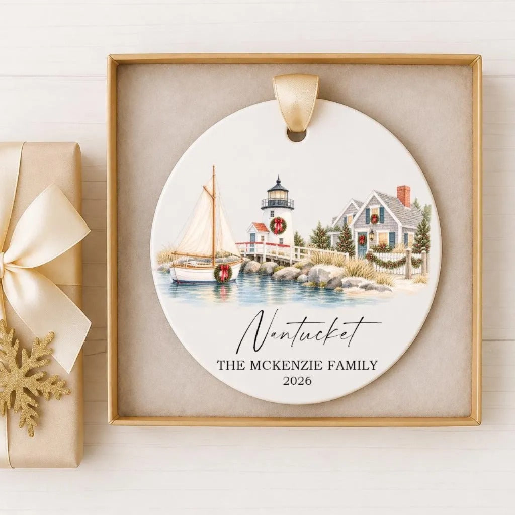 A decorative ornament featuring a sailboat on a body of water, with a lighthouse in the background, and a house in the distance. The text "Nantucket" and "THE McKENZIE FAMILY" are displayed, along with the year "2026".