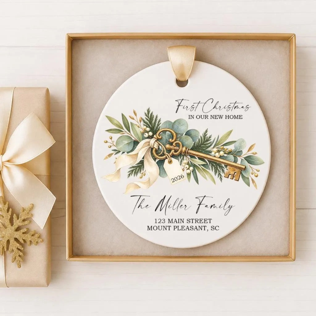 A decorative ornament with a key and greenery, placed in a gold frame.