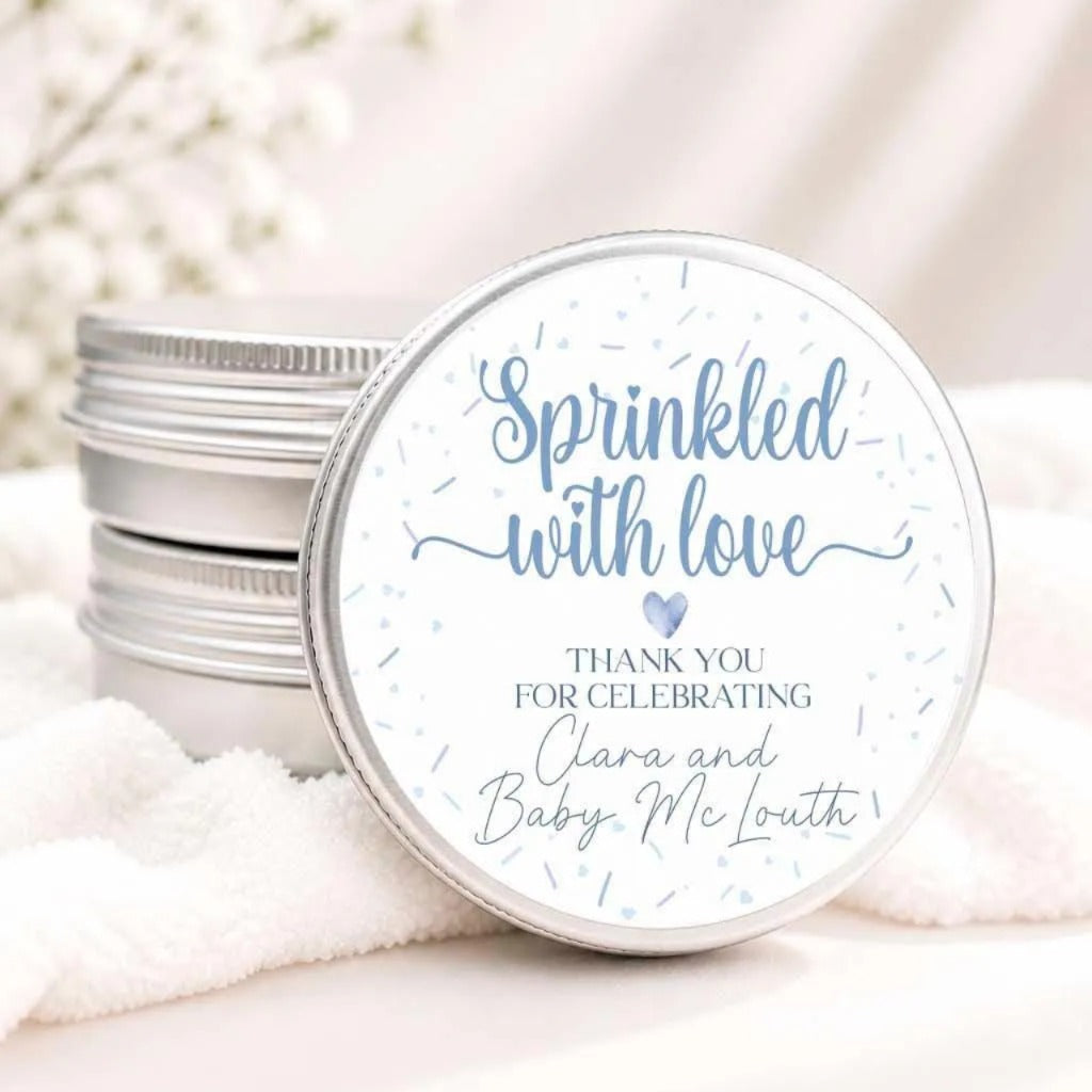 a round tin lid with a message that reads "Sprinkled with love" and "Thank you for celebrating Clara and Baby McLough".