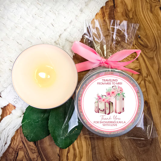 a candle next to a packaged candle on a table