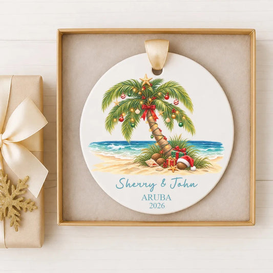 A decorative ornament featuring a palm tree with Christmas lights and ornaments, placed in a gold frame on a white background.