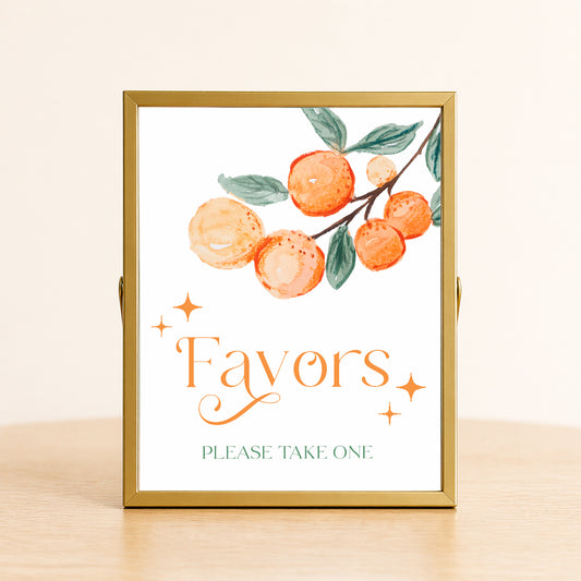 A Little Cutie baby shower favors sign with citrus design displayed on table for favor station decor.