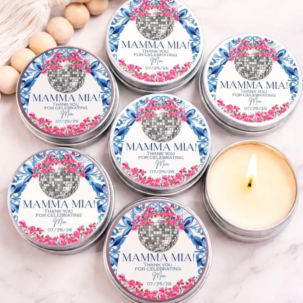 a collection of six silver tins with labels that say "MAMMA MIA! Thank you for celebrating Mina 07/25/26". The tins are arranged in a circular pattern, with one candle in the center.