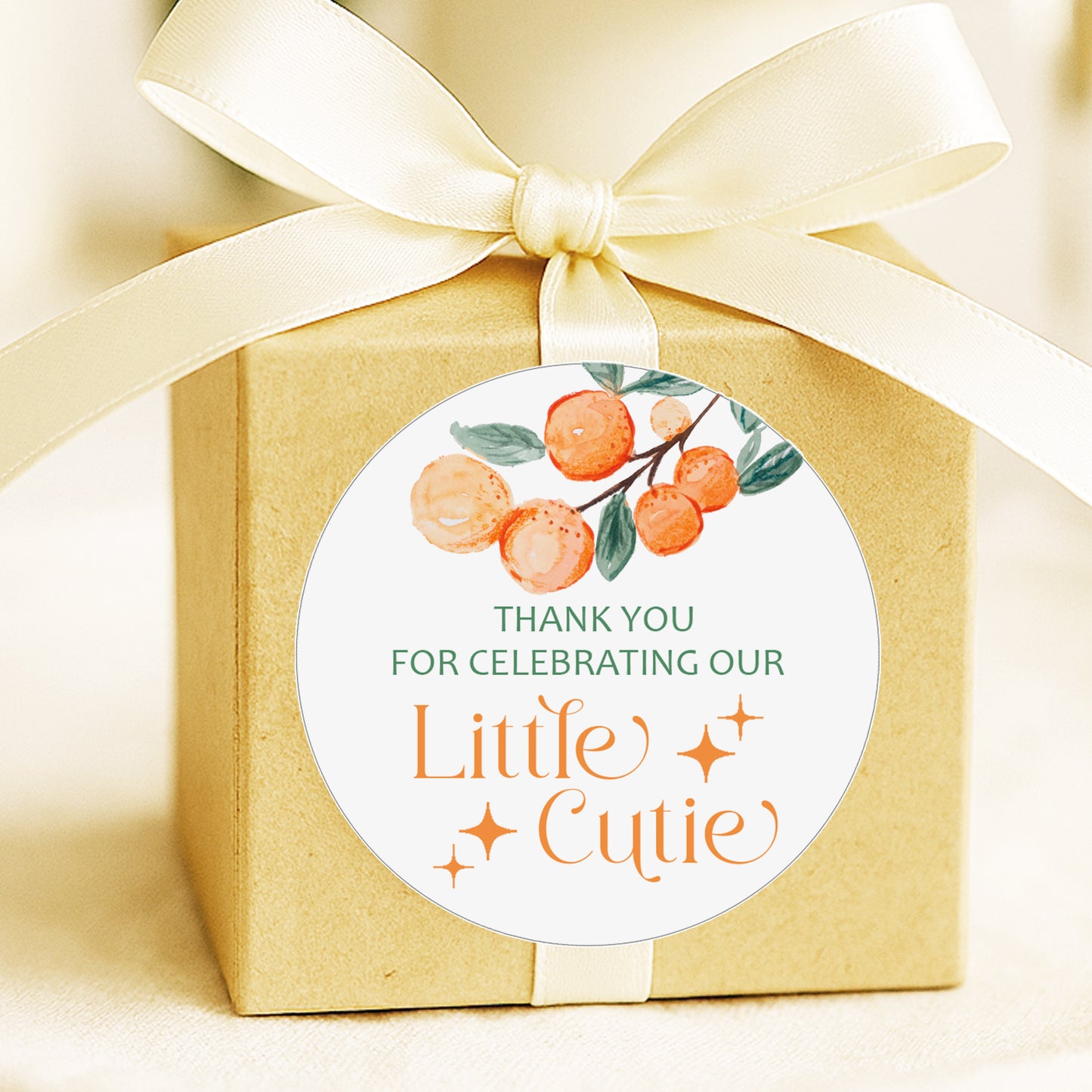 A Little Cutie baby shower thank you stickers with orange citrus design applied to favor bags for party favors.