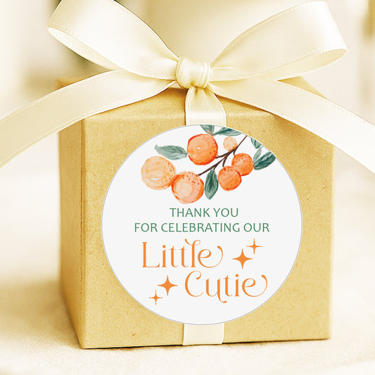A Little Cutie baby shower thank you stickers with orange citrus design applied to favor bags for party favors.
