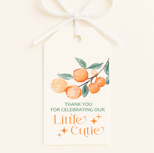 A Little Cutie baby shower favor tags with citrus orange design and thank you message attached to party favor bag with ribbon.