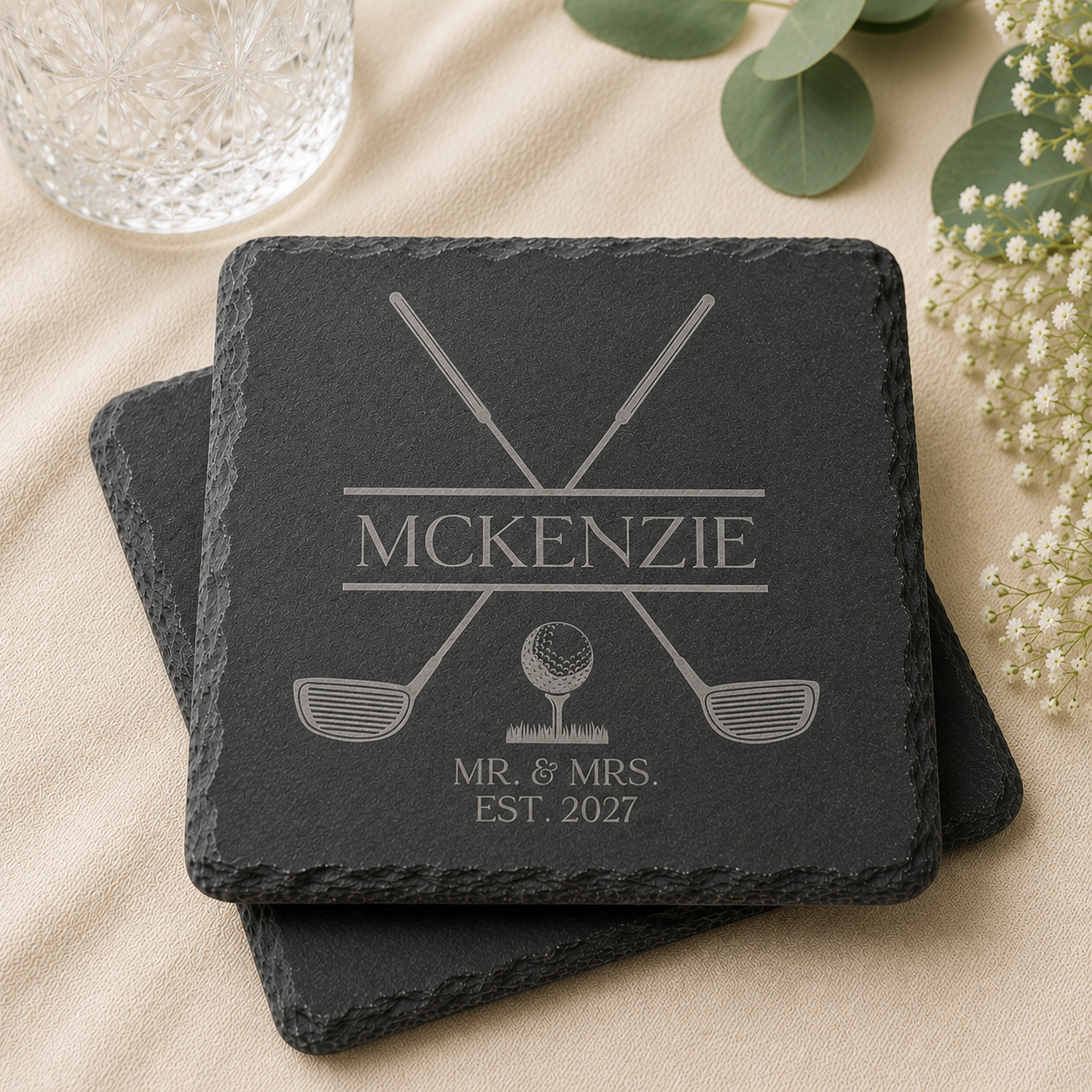 Personalized slate wedding coaster featuring crossed golf clubs, golf ball design, custom last name, and wedding year laser engraved on natural black slate.