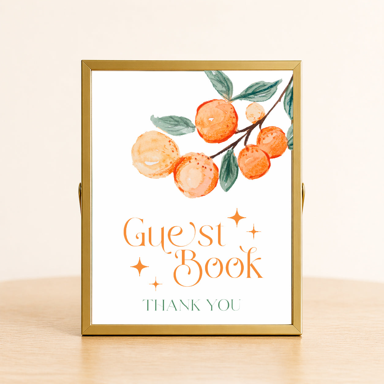 A Little Cutie baby shower guest book sign with citrus design displayed on table for sign-in station decor