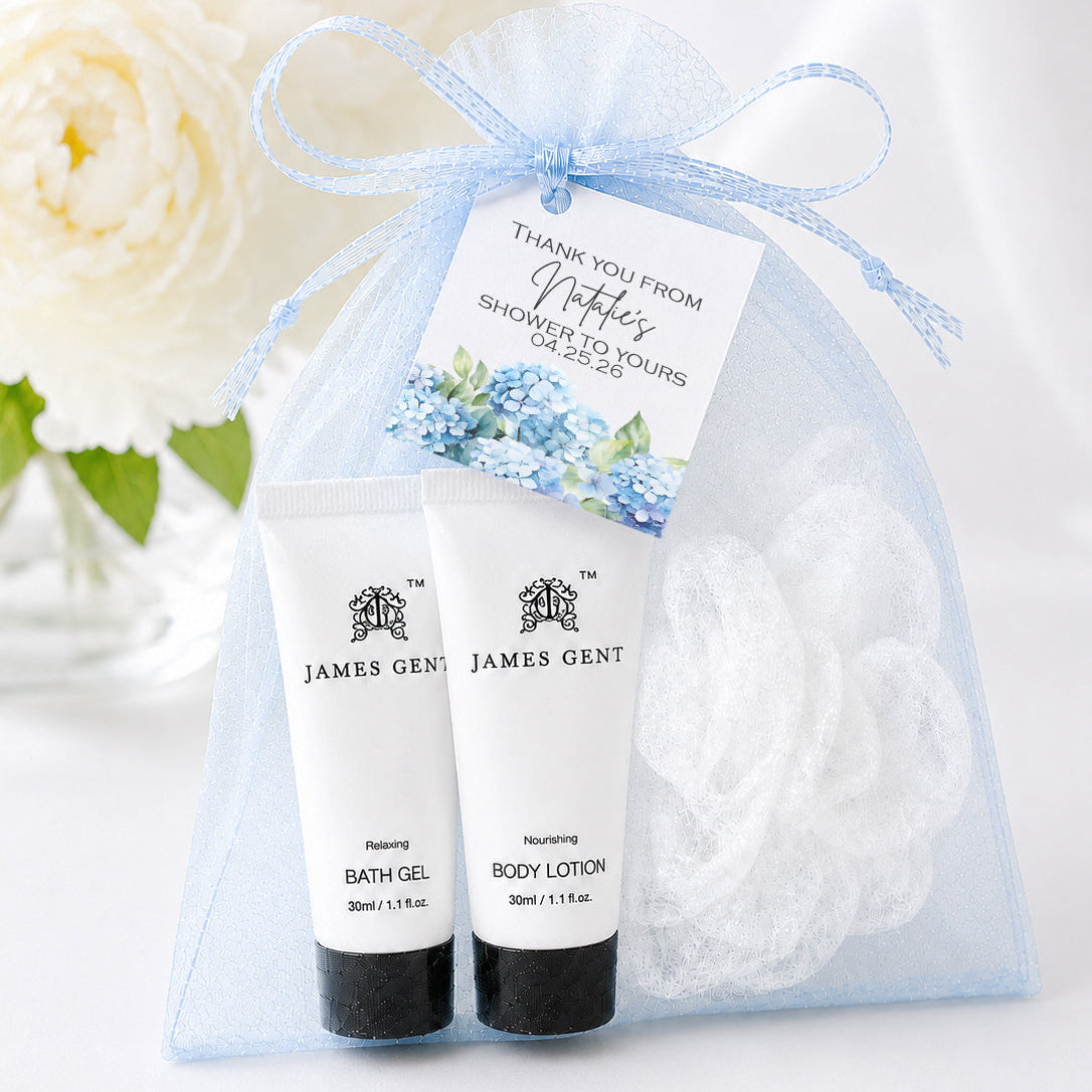 Blue hydrangea spa favor kit with shower gel, body lotion, white loofah, blue organza bag, and personalized floral favor tag for baby showers and bridal showers