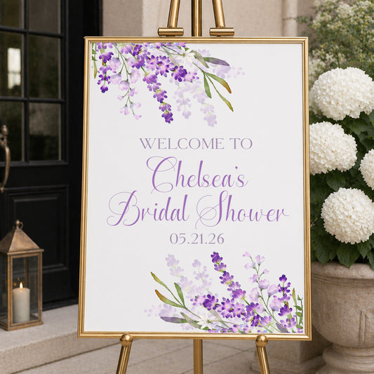 Personalized lavender welcome sign with purple floral design displayed on easel for bridal shower or wedding entrance decor.