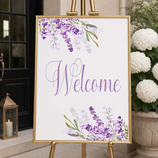 Lavender welcome sign with purple floral design displayed on easel for bridal shower or wedding entrance decor.