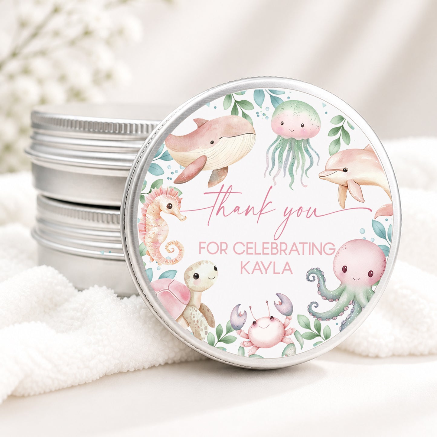 Personalized under the sea baby shower candle favor in a silver tin featuring watercolor sea animals including a whale, dolphin, jellyfish, octopus, seahorse, turtle, and crab with custom baby shower details, displayed on a soft white background.