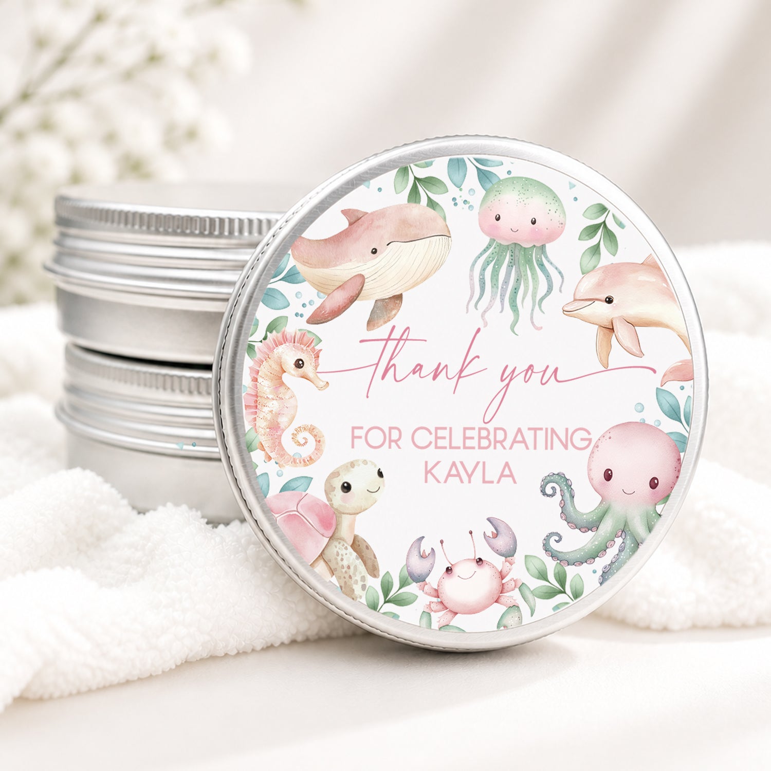 Personalized under the sea baby shower candle favor in a silver tin featuring watercolor sea animals including a whale, dolphin, jellyfish, octopus, seahorse, turtle, and crab with custom baby shower details, displayed on a soft white background.