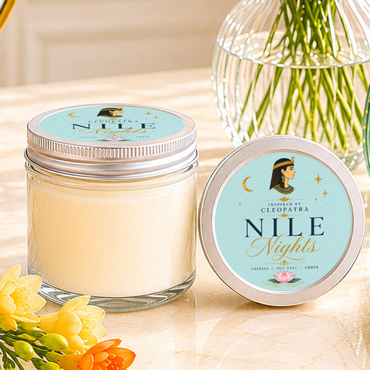 Turquoise Cleopatra inspired soy candle with freesia, sea salt, and amber fragrance notes styled with flowers and elegant feminine decor.