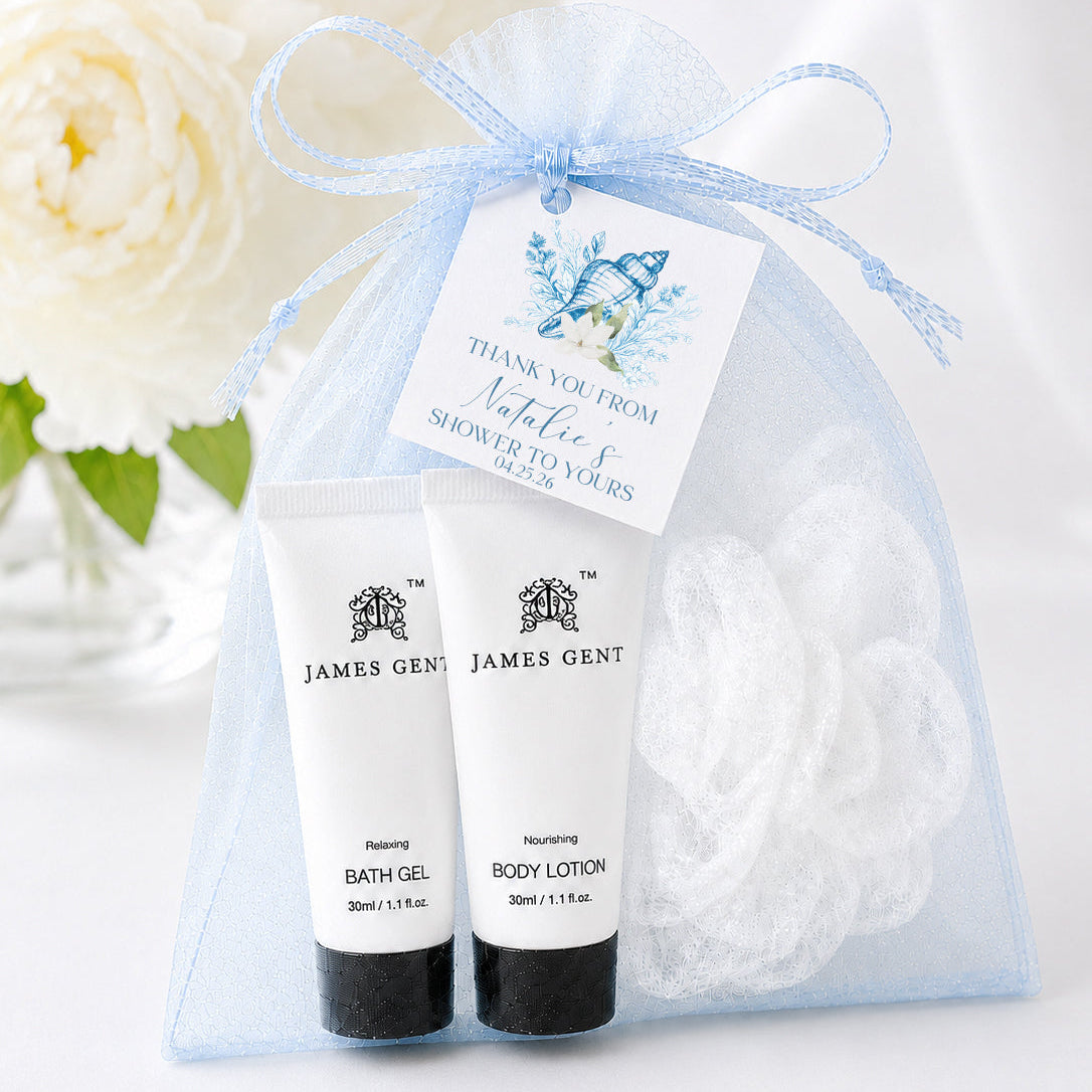 Coastal seashell spa favor kit with blue organza bag, bath gel, white loofah, and personalized favor tag for bridal showers and beach weddings.