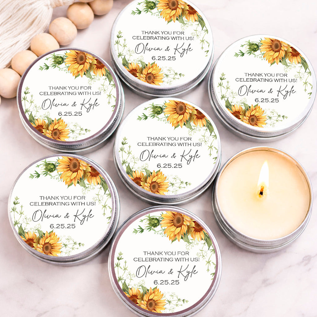 a collection of round candles with floral designs, arranged on a marble surface. The candles are labeled with "Thank you for celebrating with us" and feature personalized names and date