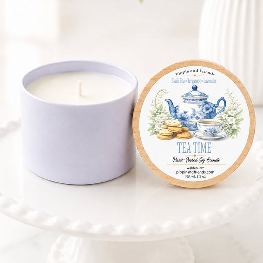 Tea time soy candle in a white ceramic vessel with a natural wood lid featuring a watercolor tea party themed label, hand-poured by Pippin and Friends