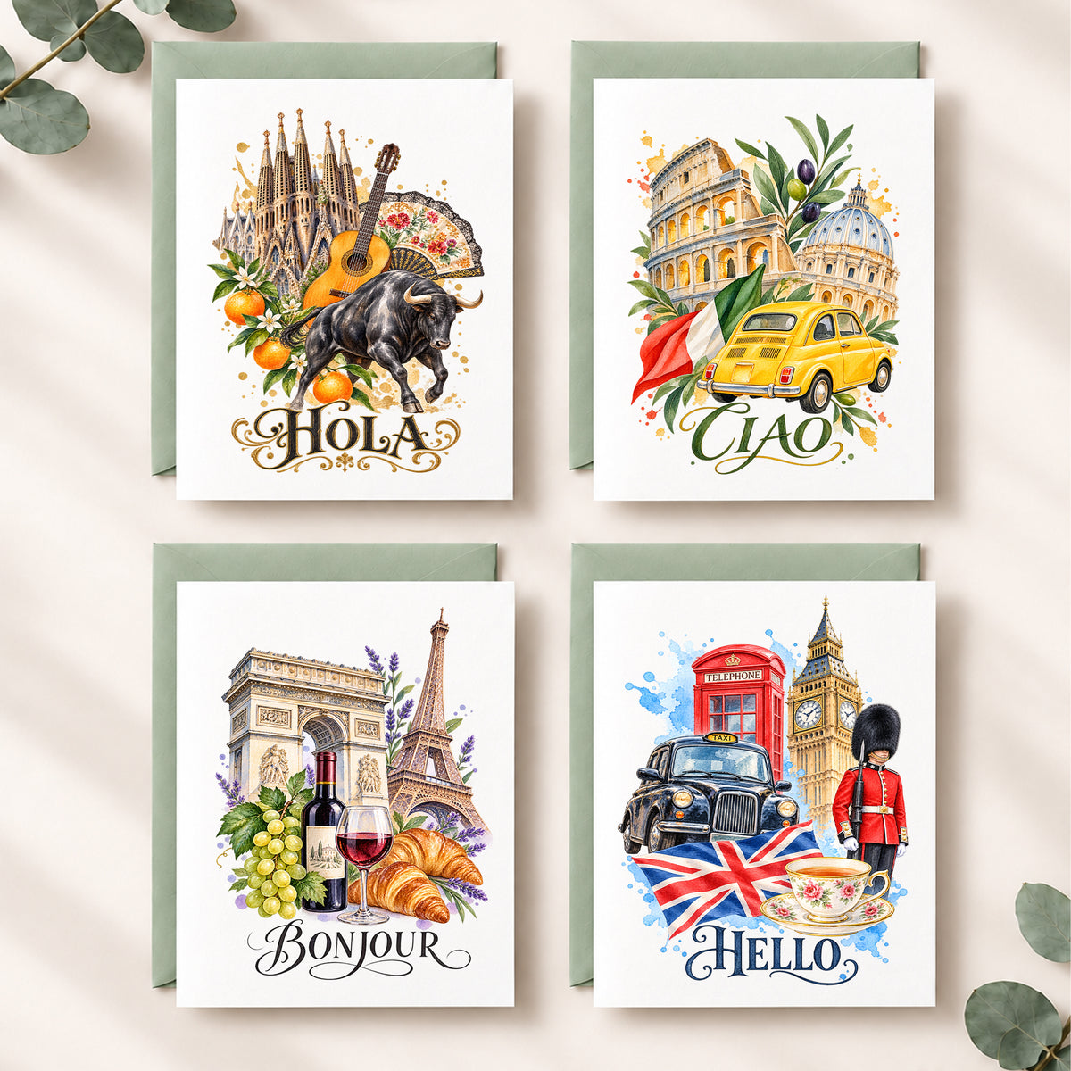 Four illustrated greeting cards arranged in a 2x2 grid on a light beige surface with eucalyptus leaves. The cards feature watercolor-style travel scenes: Barcelona with a guitar and bull, Rome with a yellow taxi, Paris with wine and croissants, and London with a red telephone booth and Union Jack.